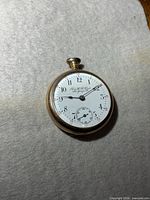 Front view of pocket watch showing dial details