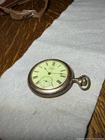 Full view of pocket watch on fabric