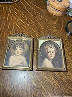 Both framed prints on table