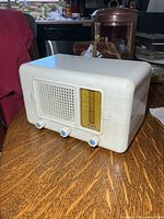 Front left view showing grille, dial, knobs