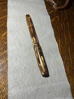 Full view of capped fountain pen on cloth
