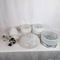 Group shot of all seven glass light covers and hardware