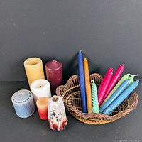 Group view of all pillar candles, tapers in basket, and wicker basket