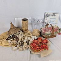 Overall lot showing placemats, napkins, glasses, shell items, bamboo vase, book and stationery