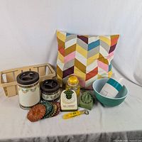 Group shot of pillow, bowls, canisters, caddy, jar, opener, sharpener, timer