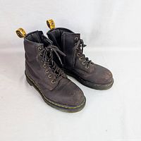 Full view of both brown Dr. Martens boots side angle