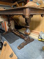 Full view of table base showing carved baluster supports and stretcher