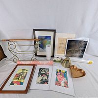 Overall lot view showing shelf, framed and unframed prints, heart dish, rolled posters