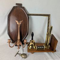 Group shot of tray, frame, candle sconce, bell, calendar, bookshelf end, coin bank, nutcracker