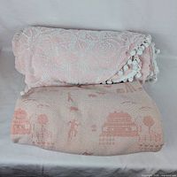 Both bedspreads folded: chenille on top, Bates underneath