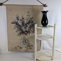 Full view of tapestry, vase on top tier, three-tier stand