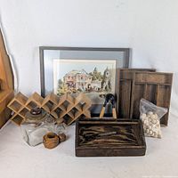 Group shot of all items including toolbox, rack, trays, jar, pot, nutcrackers, wood balls, framed print