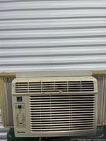 Front view of Danby window air conditioner showing grille, control panel, and side panels
