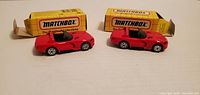 Two red Matchbox Dodge Viper RT/10 diecast cars with their yellow boxes, front three-quarter view.