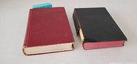 Front view of red and black hardcover prayer books
