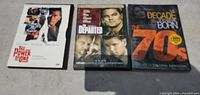 Front view of three DVD cases: The Power of One, The Departed, The Decade You Were Born: The 70s