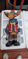 Moose figure in styrofoam insert showing overall design and attached power cord