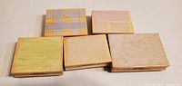 Top view showing five wood blocks with pastel sample designs