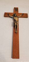 Front view of wooden crucifix with metal corpus and INRI plaque