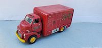 Left front and side view of red diecast cab-over delivery truck with Linde logo