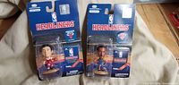 Front view of both sealed Headliners figures showing packaging and players