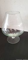 Full view of large clear brandy snifter showing shape and size