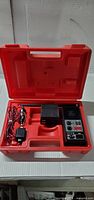 Radio set inside red case with accessories