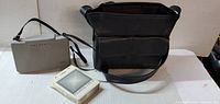 Overall lot: grey Polaroid 103 clamshell case, black Polaroid shoulder bag, boxed film