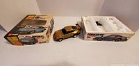 Box, gold Porsche 911 body, plastic tray interior visible