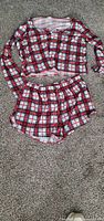 Complete two-piece plaid pajama set laid flat (top and shorts)