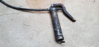 Full view of grease gun with hose extended