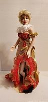 Front view of Franklin Mint Marilyn Monroe porcelain doll in gold and red gown