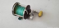 Overall view of Penn Peerless No.9 reel showing spool filled with green line and yellow handle knob