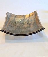 Top view showing metallic mottled interior surface and curved shape