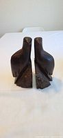 Front view of both carved bird bookends standing upright