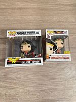 Front view of both boxed Funko Pop figures showing character, numbers and exclusive stickers