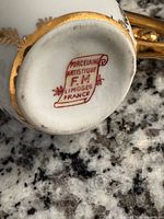 Bottom of handled vessel showing FM Limoges mark