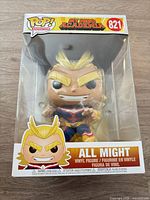 Front view of boxed All Might Funko Pop showing figure and product details
