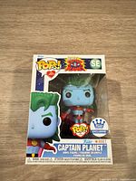 Front of boxed Captain Planet SE Funko Pop showing figure through window and stickers
