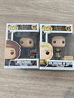 Front view of both boxed figures showing exclusivity stickers and figure visibility