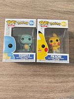 Front view of both boxed Funko Pop figures