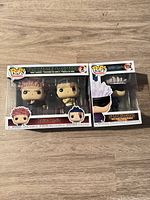 Front view of both boxed Funko Pop figures