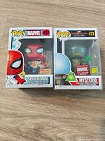 Front view of both boxed figures showing characters, numbering and exclusivity stickers