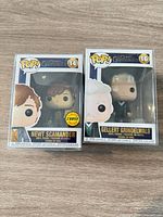 Front view of both boxed figures showing character art and numbers 14 and 16