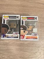Front view of both boxed Funko Pop! figures in protectors