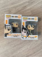 Front view of both boxed figures showing characters, pop numbers and series branding