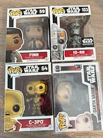 Front view of four boxed Funko Pop Star Wars figures IG-88, Finn, C-3PO, Darth Vader