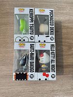 Side and angled view of all four boxed figures stacked, showing windows and side artwork