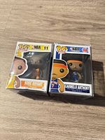Front view of both Funko Pop boxes in protectors