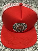 Front view of red trucker hat with Hawkins High School patch